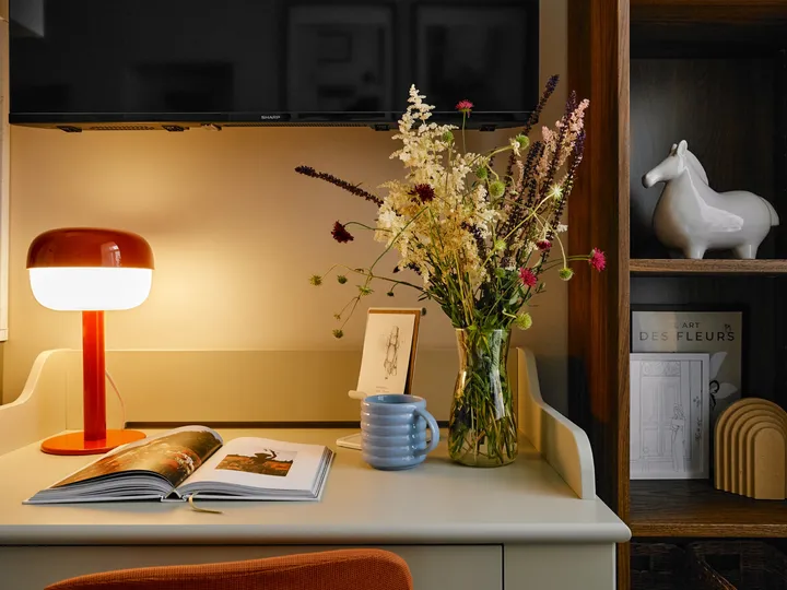 Desk with a red lamp and shelving