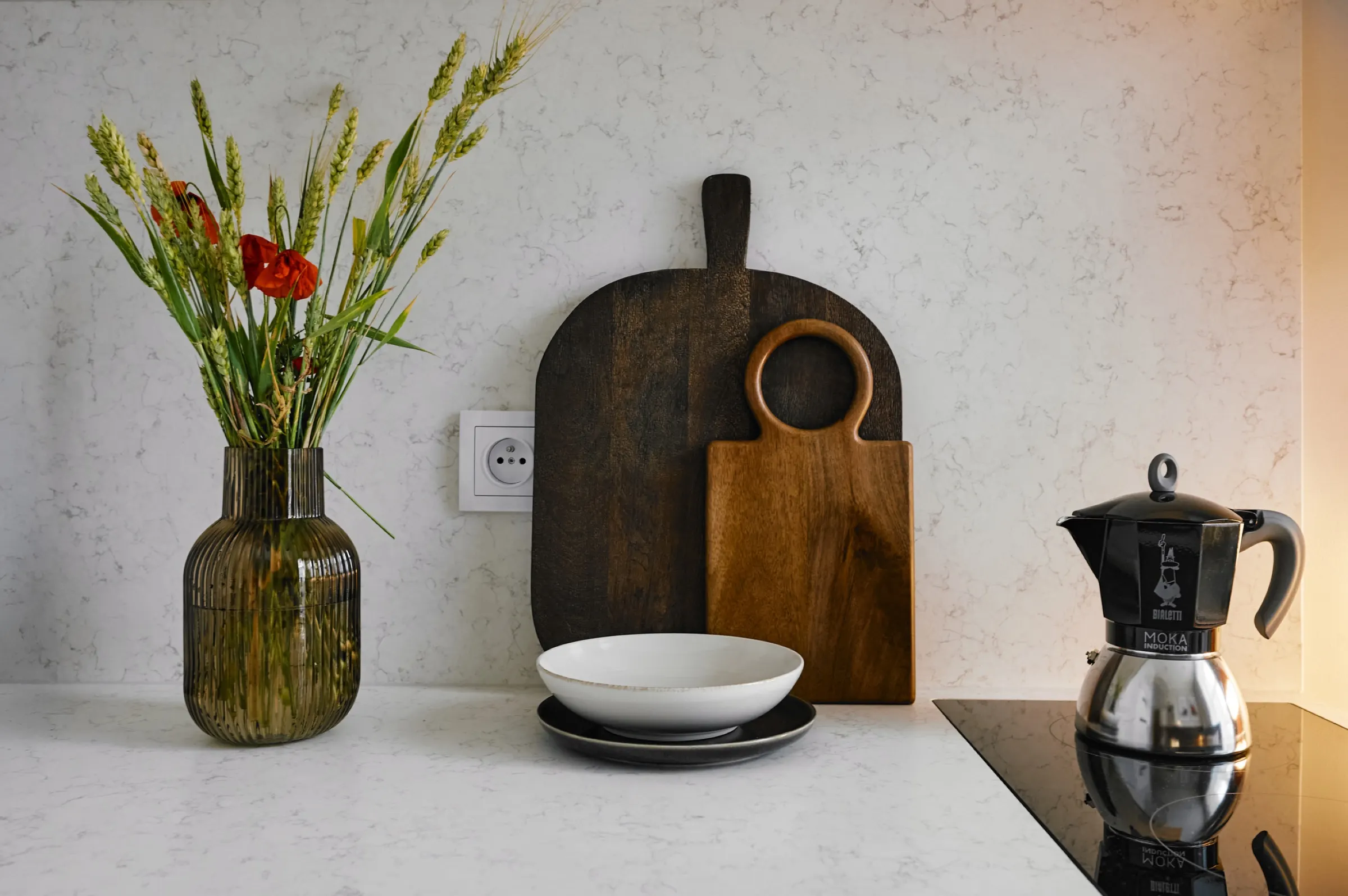 Worktop with a board, moka pot and vase