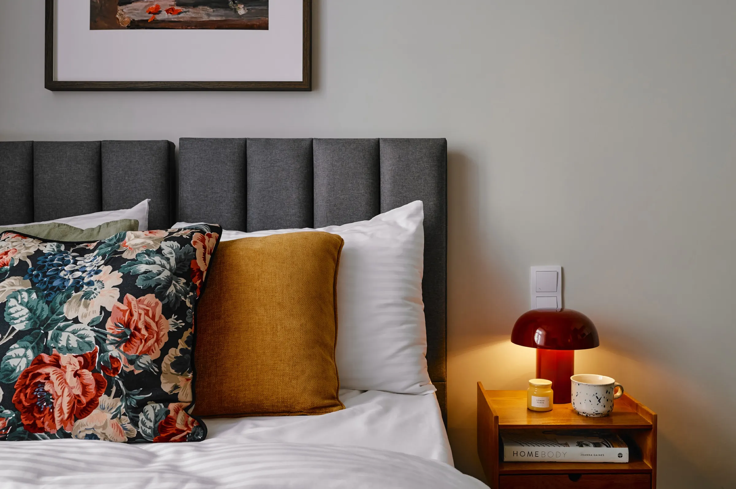 Floral cushions and a bedside lamp