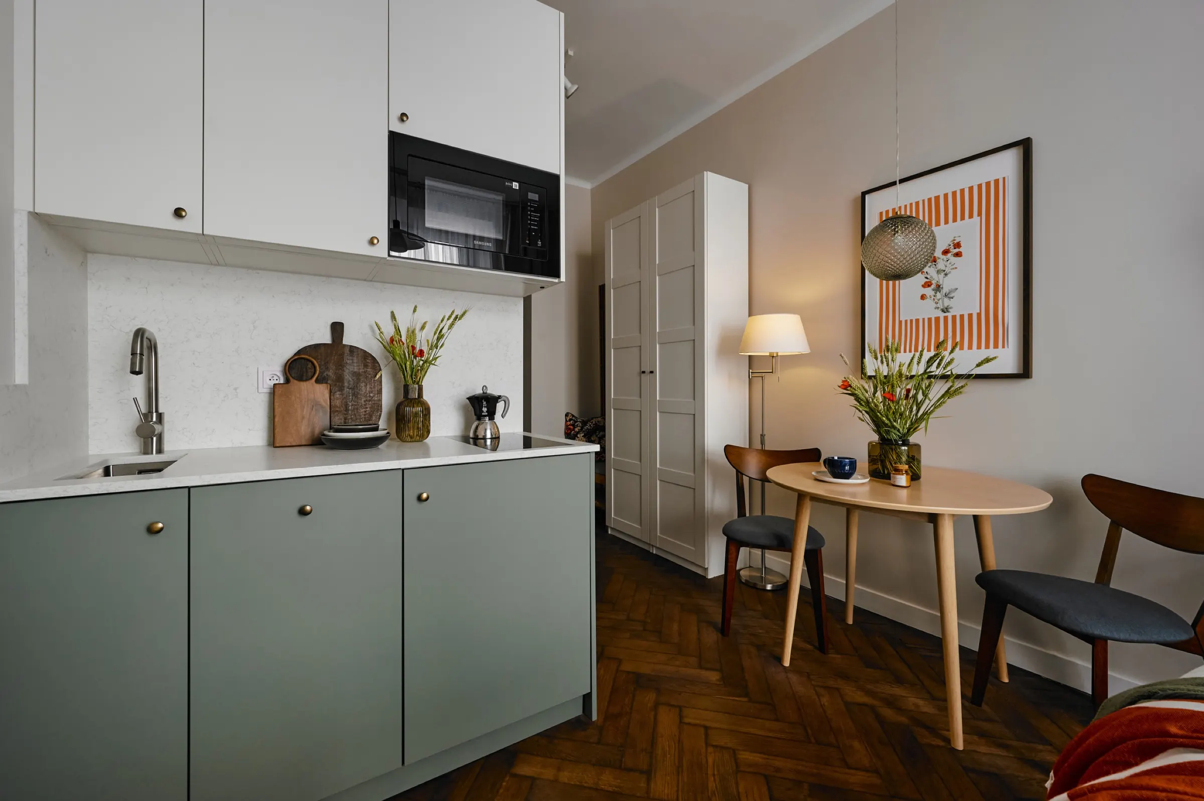 Sage-green kitchenette with a dining table