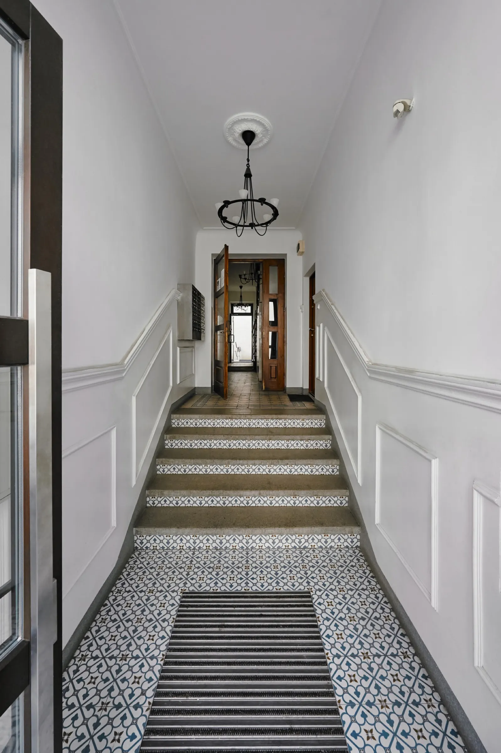 Tenement staircase with patterned floor tiles