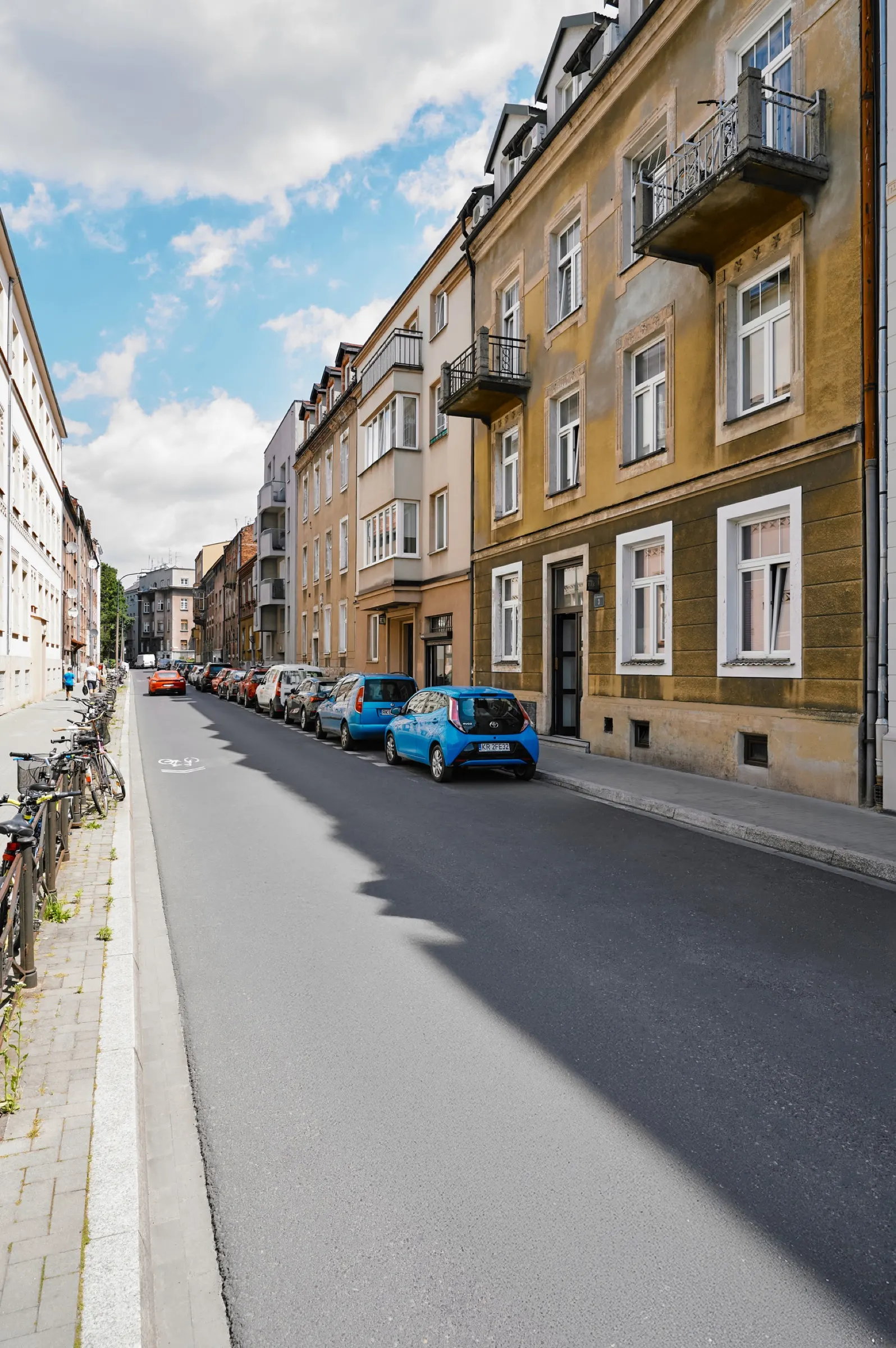 Konarskiego Street lined with tenement houses in the sun