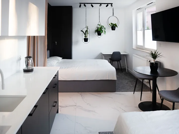 Kitchen with a white worktop, looking towards the bedroom